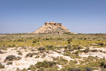 Spain, Bardenas Reales: Panorama view of famous Spanish natural semi desert sierra natural preserve park with Pisquerra rocky mountain chain, wide plains and blue sky - concept travel nature badlands