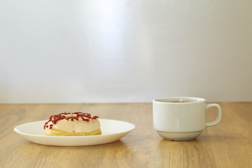 Donut with black coffee on wooden