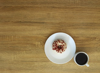 Donut with black coffee on wooden