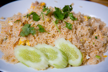 Crab meat fried rice, Khao Pad Poo. Thai famous street food. Thai recommend menu for tourist. fried rice with crab meat and egg, cucumber on side dish.