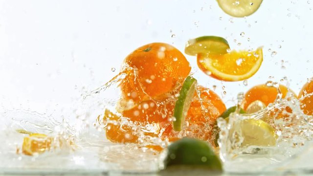 Fresh citruses dropped into water with splash, shooted with high speed cinema camera at 1000 fps. 4K footage.