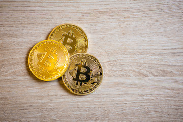 Golden bitcoins on wooden background