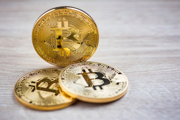 Golden bitcoins on wooden background