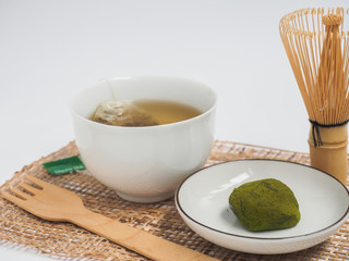 green tea daifuko traditional Japanese food and hot green tea on white background.