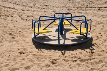 Empty carousel in the beach playground.