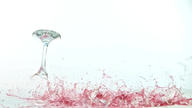 Breaking wine glass on white background, shooted with high speed cinema camera at 1000 fps. 4K footage.