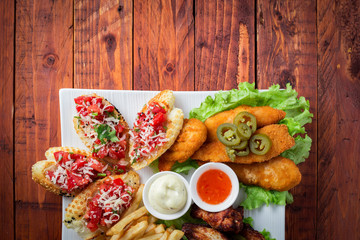 Big and tasty combo of nuggets, french fries, fried chicken legs and canape