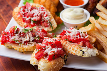 Big and tasty combo of nuggets, french fries, fried chicken legs and canape
