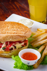 Hamburger with french fries on wooden background