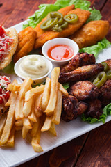 Big and tasty combo of nuggets, french fries, fried chicken legs and canape