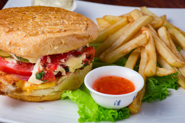 Hamburger with french fries on wooden background
