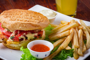 Hamburger with french fries on wooden background