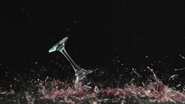 Breaking wine glass on black background, shooted with high speed cinema camera at 1000 fps. 4K footage.