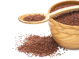 Wooden bowl and spoon with red quinoa seeds with white background