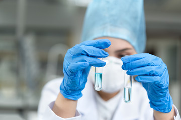Female scientist looking at the scientific sample in the CDC laboratory