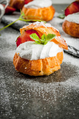 Profiteroles with whipped cream, strawberries and mint
