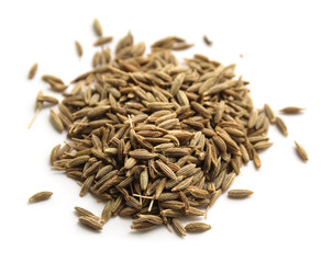 Pile of cumin seeds on white. Macro with shallow depth of field.
