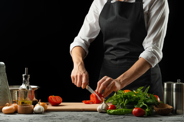 Close the chef's hands, preparing an Italian tomato sauce for macaroni.pizza. The concept of the...