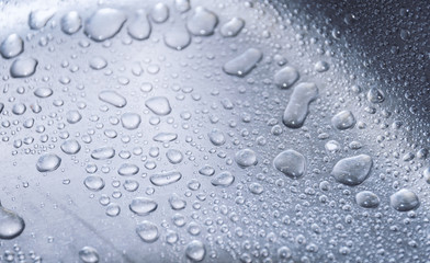 Water drops on metal surface. Macro with shallow depth of field.