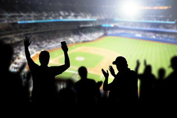 Fototapeta Baseball fans and crowd cheering in stadium and watching the game in ballpark. Happy people enjoying a match and sport event in arena. Friends watching ballgame live. obraz
