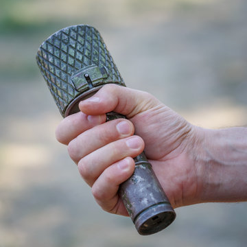 Antitank grenade in the male hand close-up