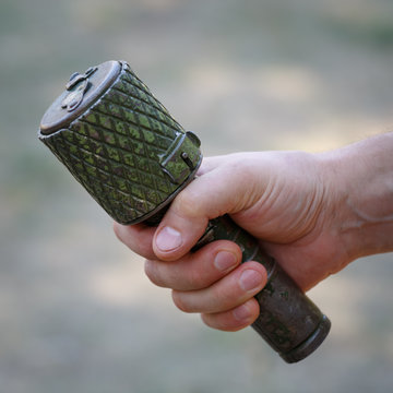 Antitank grenade in the male hand close-up