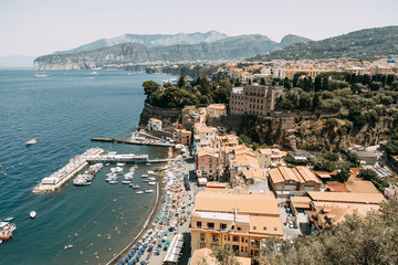 Fototapeta na wymiar Views of the city of Sorrento in Italy, panorama and top view. Night and day, the streets and the coast. Beautiful landscape and brick roofs. Architecture and monuments of antiquity.
