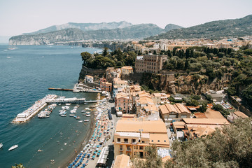 Fototapeta premium Views of the city of Sorrento in Italy, panorama and top view. Night and day, the streets and the coast. Beautiful landscape and brick roofs. Architecture and monuments of antiquity. Shops and street