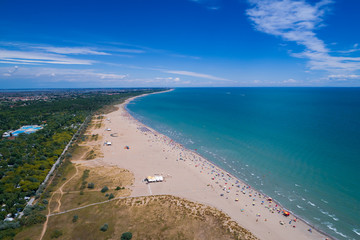 Italy, the beach of the Adriatic sea. Rest on the sea near Venice. Aerial FPV drone photography.