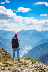 Fototapeta na wymiar Hiker woman standing up achieving the top Dolomites Alps.