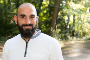 Attractive man with beard and bald head enjoy vacation day outdoors