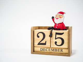 Santa Clause sitting on the wooden block calendar date December 25 waiting for Christmas ,...