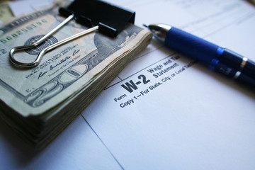 W-2 Tax form with Twenty Dollar Bills & Pen