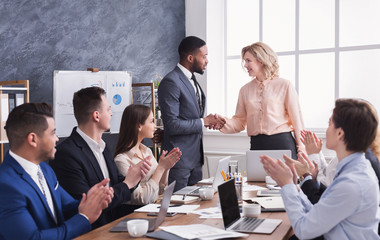 Group of cheerful business people sitting at meeting