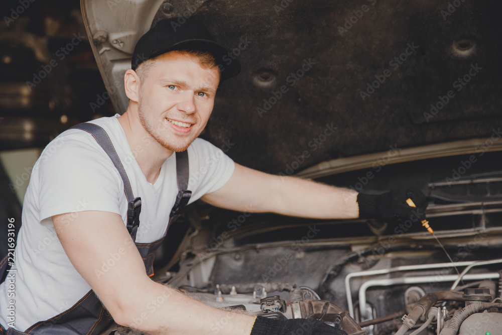 Wall mural car mechanic working diagnostic equipment at automotive service