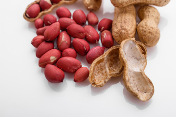 fresh peanuts on a white acrylic background
