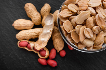 fresh peanuts on a dark stone background