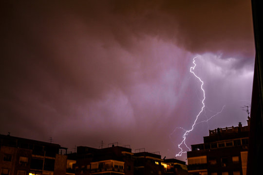 Thunderbolt falling on a stormy night in the city.  