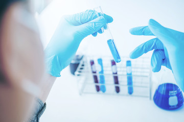 Scientist with equipment holding tools during scientific experiment science concept
