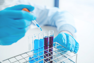 Scientist with equipment holding tools during scientific experiment science concept