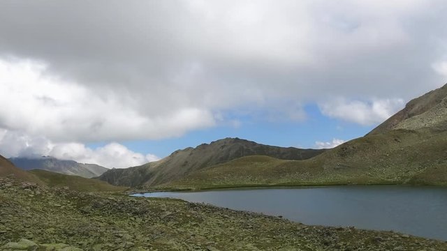 Time lapse lake scenes in mountains, national park Dombai, Caucasus, Russia, Europe. Summer landscape, sunshine weather, blue sky and sunny day