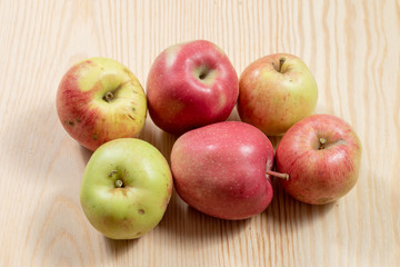 Bunch of ripe apples on a wooden table