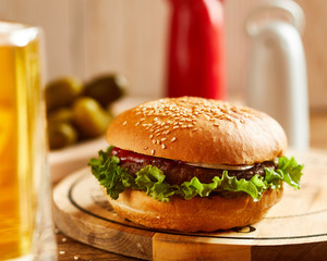 Fresh delicious burger, served on wooden board