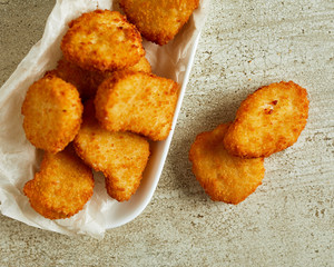 Fried chicken nuggets served on white plate