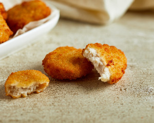 Fried chicken nuggets served on white plate