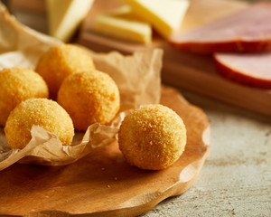 Fresh homemade cheese balls on wooden cutting board