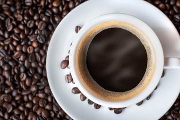 Hot coffee cup with roasted coffee beans background