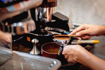Fototapeta na wymiar Barista preparing grinded coffee in counter