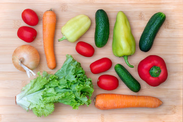Fresh vegetables on wooden cutting board.