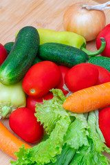 Fresh vegetables on wooden cutting board.